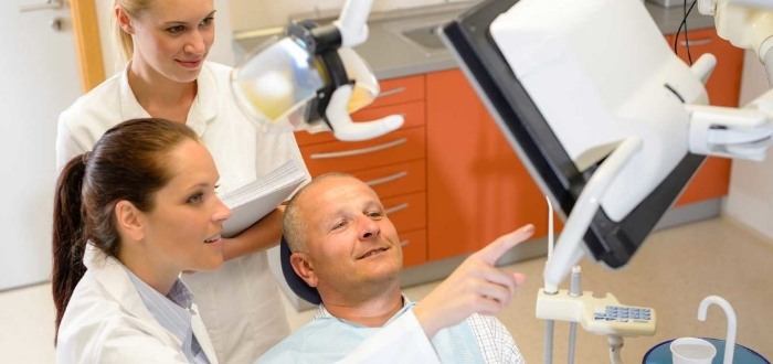 Dentist and team member showing dental implants in Schaumburg to a patient