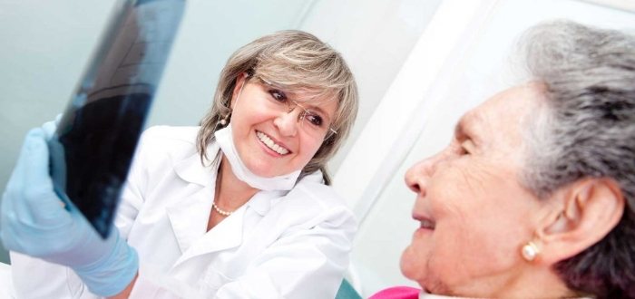 Dentist and patient discussing dentures in Schaumburg