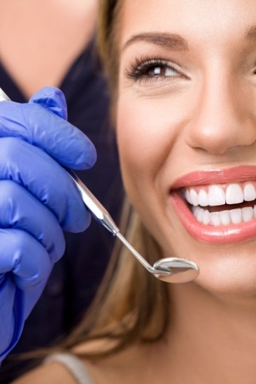 Smiling woman receiving dental treatment