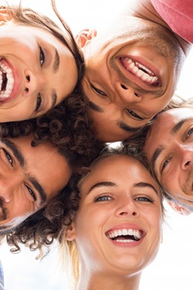 Group of friends smiling brightly in a circle