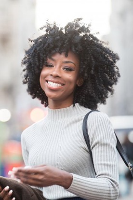 Woman smiling confidently while she’s out on the town