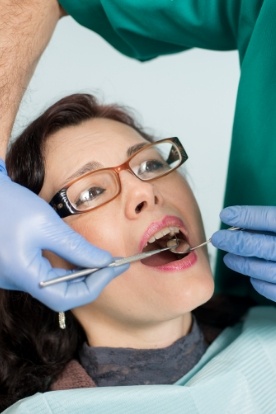 Woman receiving dental exam from her Schaumburg emergency dentist