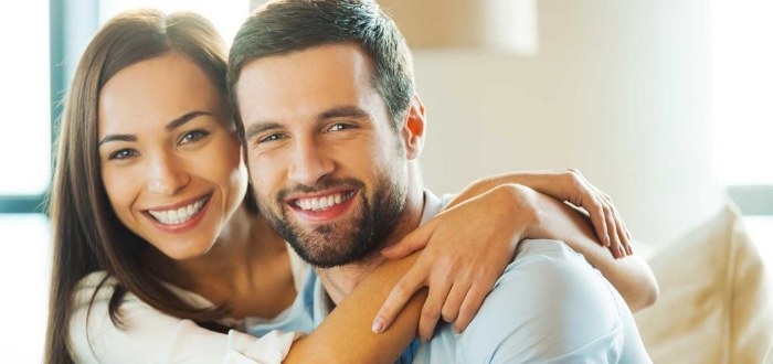 Smiling man and woman with dental veneers in Schaumburg