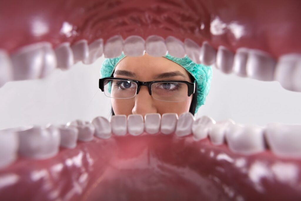 A dentist looking at a pair of dentures