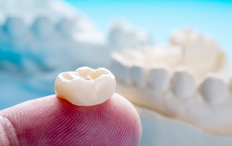 Dental crown on a fingertip